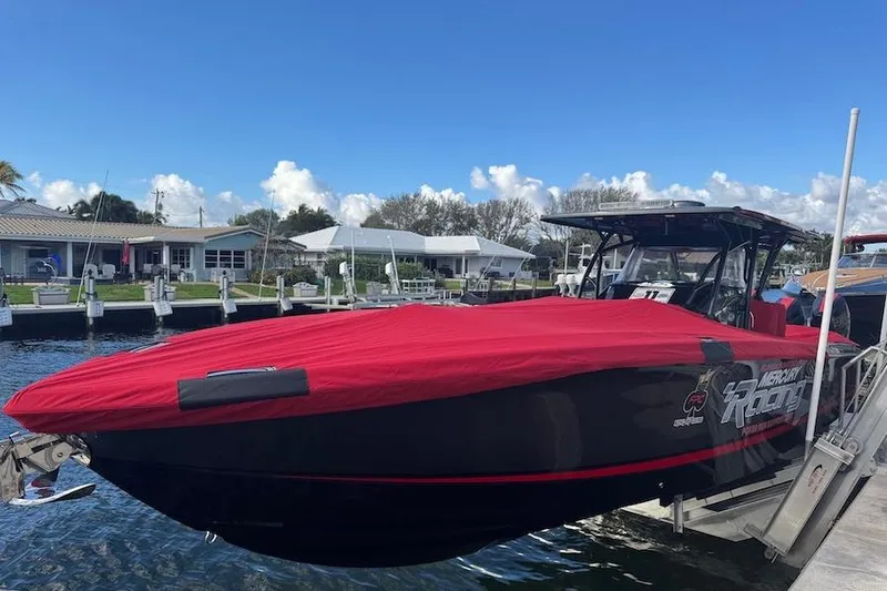  Yacht Photos Pics 2025 Nor-Tech 390 Sport Center Console boat with red cover docked at marina.