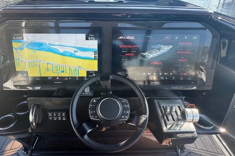  Yacht Photos Pics 2025 Nor-Tech 390 Sport Center Console dashboard with dual Garmin displays and steering wheel.