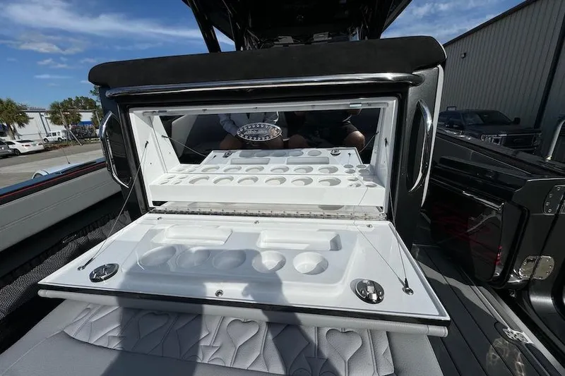  Yacht Photos Pics 2025 Nor-Tech 390 Sport Center Console with open storage compartment, showcasing sleek design.