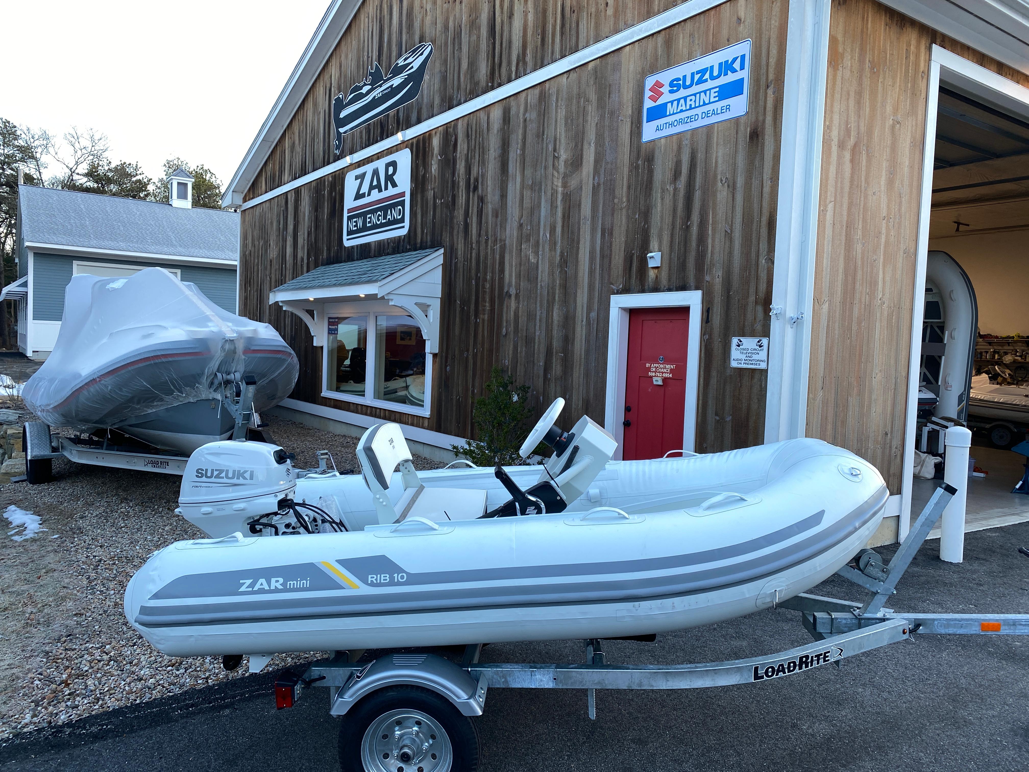 2022 ZAR Mini Rib HDL10 inflatable boat on trailer outside dealership.