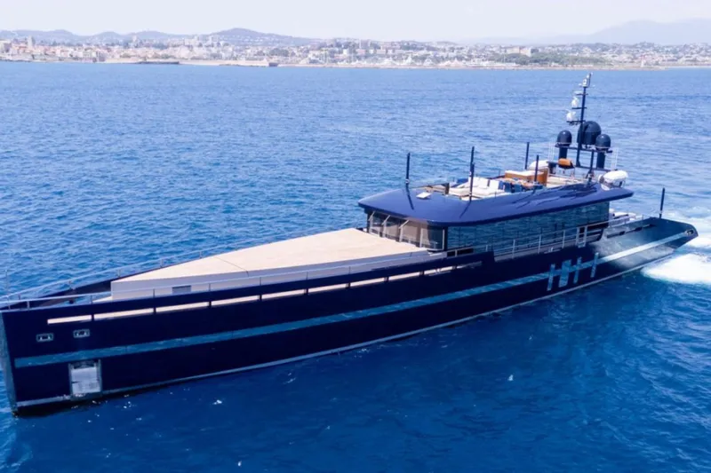  Yacht Photos Pics Luxurious 2009 MMGI 44m yacht cruising on blue ocean near coastal city.