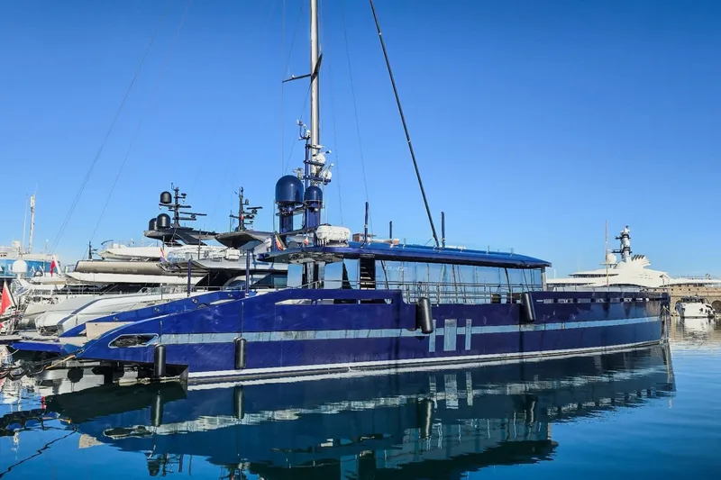  Yacht Photos Pics Blue MMGI 44m yacht from 2009 docked in a marina under clear skies.