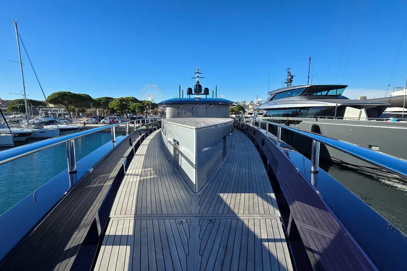  Yacht Photos Pics Luxury yacht deck view, MMGI 44m model, 2009, docked in a marina under clear blue sky.