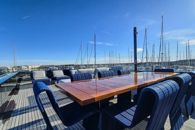  Yacht Photos Pics Luxurious yacht deck with elegant seating, MMGI 44m model, 2009, in a sunny marina setting.