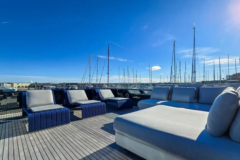 Yacht Photos Pics Luxurious MMGI 44m yacht deck with plush seating, marina view, clear blue sky, 2009 model.