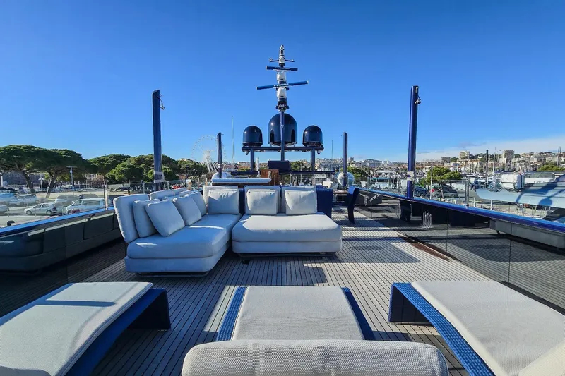  Yacht Photos Pics Luxurious MMGI 44m yacht deck with plush seating, 2009 model, docked in a scenic marina.
