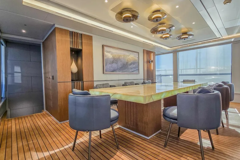  Yacht Photos Pics Luxurious yacht dining area with elegant wood flooring and modern decor, MMGI 44m, 2009 model.