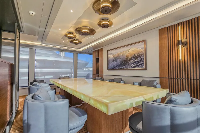  Yacht Photos Pics Luxurious yacht interior with elegant dining area, modern lighting, and ocean-themed artwork, MMGI 44m, 2009.