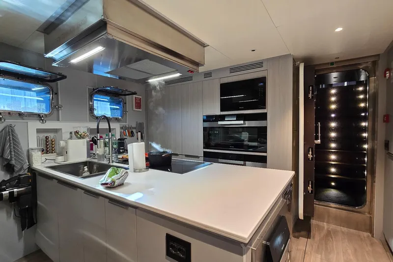  Yacht Photos Pics Modern yacht kitchen with sleek appliances, island counter, and ambient lighting, MMGI 44m, 2009.