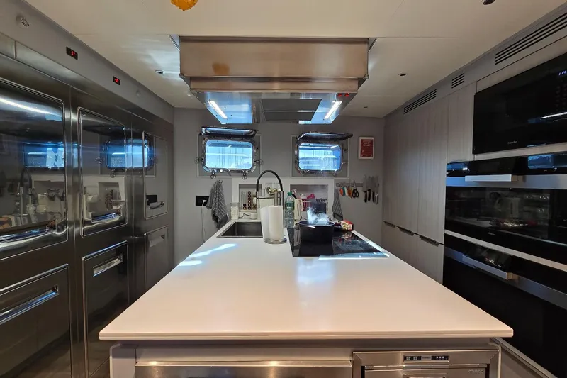  Yacht Photos Pics Modern yacht kitchen interior with stainless steel appliances, sleek countertops, and ample storage, MMGI 44m 2009.
