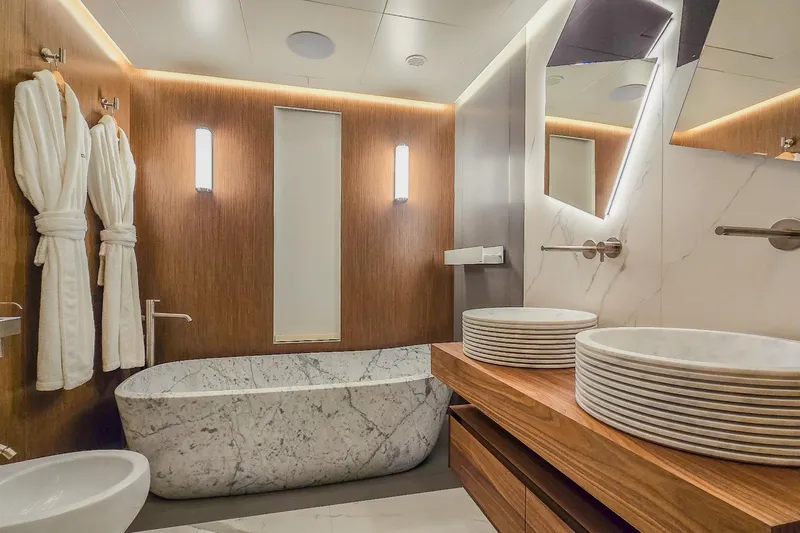  Yacht Photos Pics Luxurious yacht bathroom with marble bathtub, dual sinks, and wooden accents, MMGI 44m, 2009.
