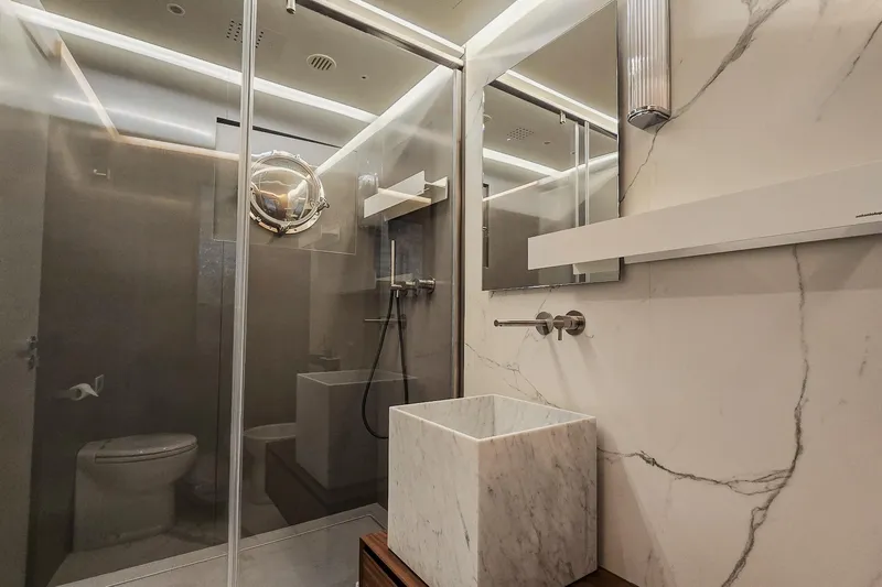  Yacht Photos Pics Luxurious modern bathroom with marble sink, glass shower, and sleek fixtures on MMGI 44m yacht.