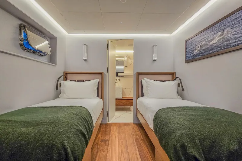  Yacht Photos Pics Luxurious twin cabin interior on 2009 MMGI 44m yacht, featuring modern decor and cozy bedding.