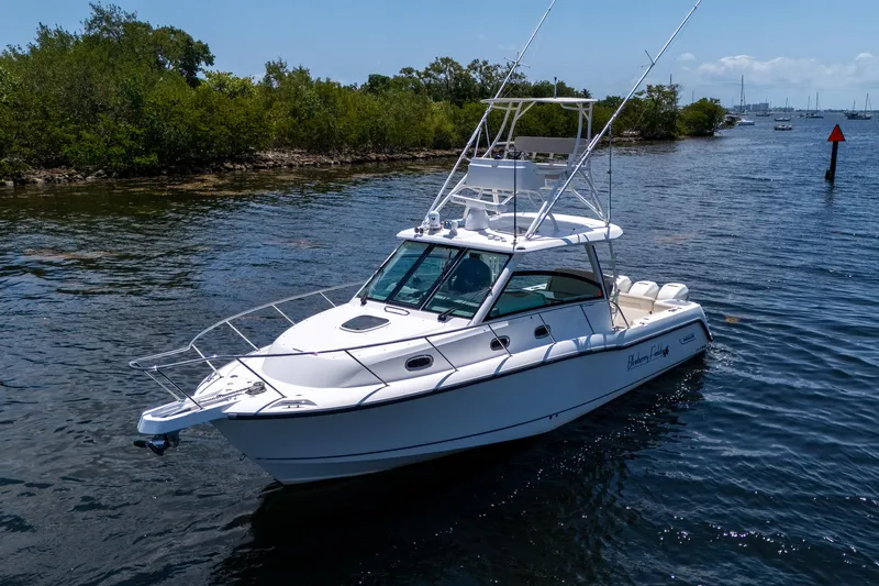  Yacht Photos Pics 2015 Boston Whaler 345 Conquest boat cruising on a calm waterway.