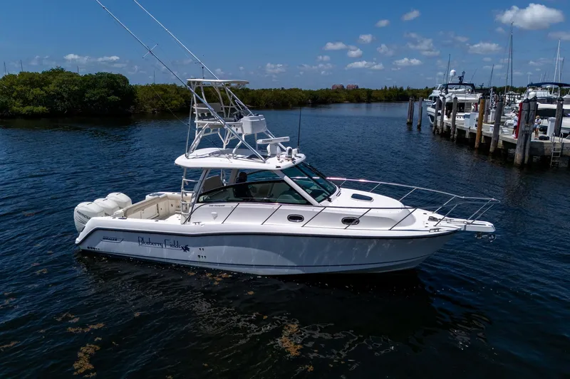  Yacht Photos Pics 2015 Boston Whaler 345 Conquest boat on calm water, clear sky background.