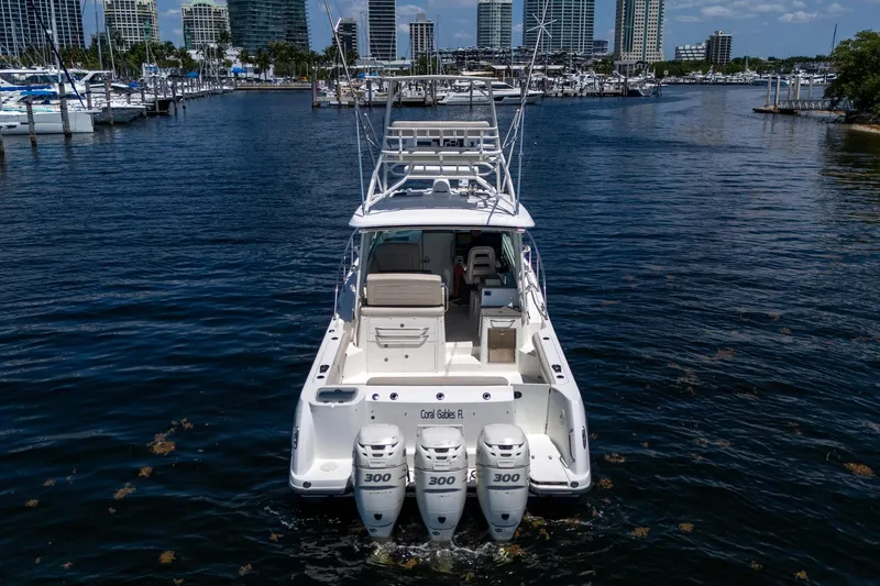 Yacht Photos Pics 2015 Boston Whaler 345 Conquest boat with triple 300 engines in a marina setting.
