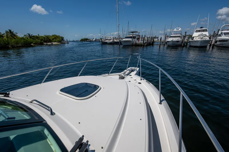  Yacht Photos Pics Boston Whaler 345 Conquest 2015 in marina, clear sky, calm water, docked boats.