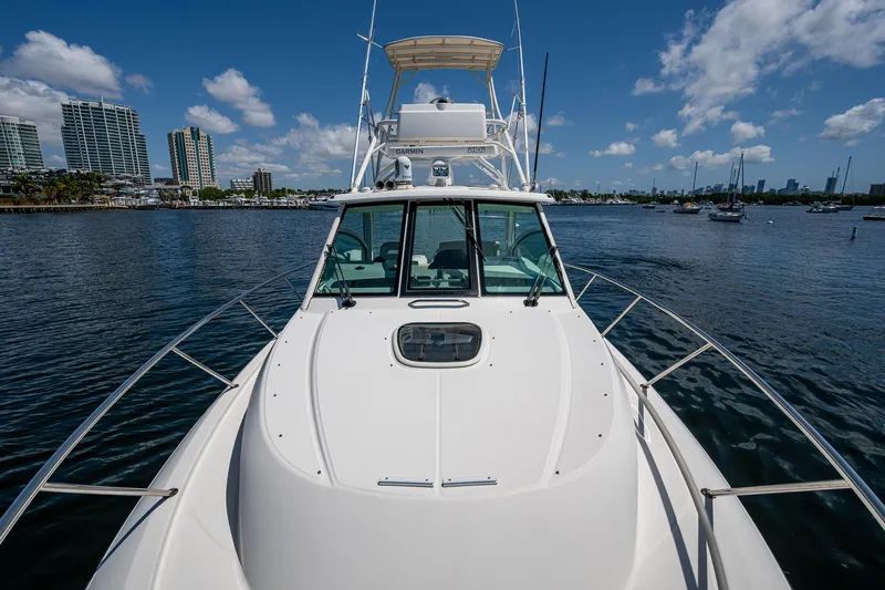 Yacht Photos Pics 2015 Boston Whaler 345 Conquest boat on calm water, city skyline in background.