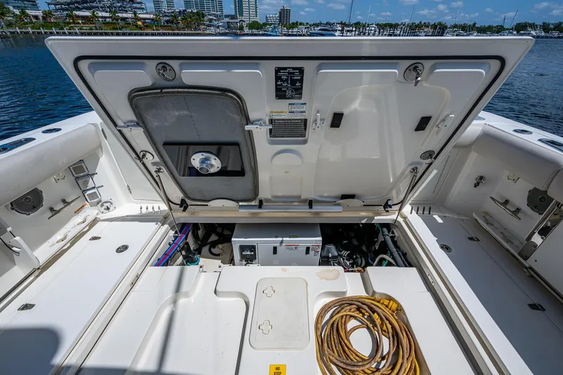  Yacht Photos Pics 2015 Boston Whaler 345 Conquest engine compartment with open hatch, dockside view.