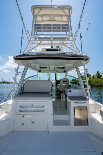  Yacht Photos Pics 2015 Boston Whaler 345 Conquest boat with tower, docked on a sunny day.