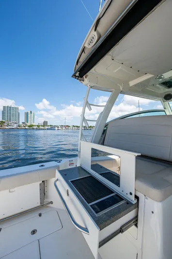  Yacht Photos Pics 2015 Boston Whaler 345 Conquest boat interior with ocean view and city skyline.