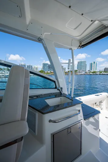  Yacht Photos Pics 2015 Boston Whaler 345 Conquest interior with sink, overlooking marina and city skyline.