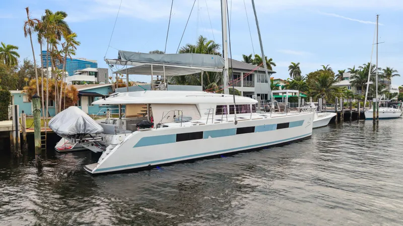 Nomada Yacht Photos Pics 2014 Lagoon 620 catamaran docked in a tropical marina setting.