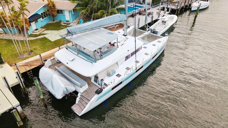 Nomada Yacht Photos Pics Lagoon 620 catamaran docked at a marina, 2014 model, aerial view.