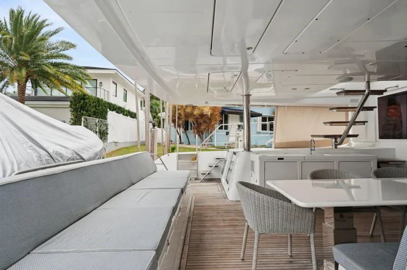 Nomada Yacht Photos Pics Spacious deck of 2014 Lagoon 620 yacht with seating and dining area.