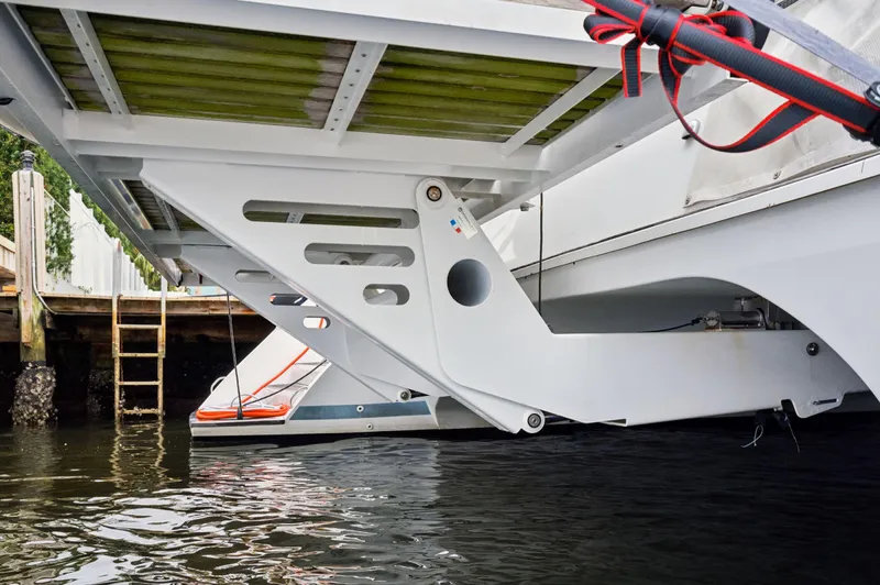 Nomada Yacht Photos Pics Underneath view of a 2014 Lagoon 620 catamaran docked by the water.