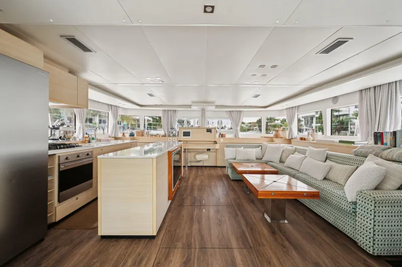 Nomada Yacht Photos Pics Luxurious interior of 2014 Lagoon 620 yacht with modern kitchen and spacious seating area.
