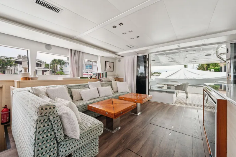 Nomada Yacht Photos Pics Luxurious interior of 2014 Lagoon 620 yacht with modern seating and wooden accents.