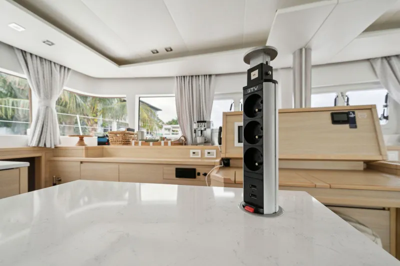 Nomada Yacht Photos Pics Luxurious interior of 2014 Lagoon 620 yacht with modern kitchen and pop-up power outlets.