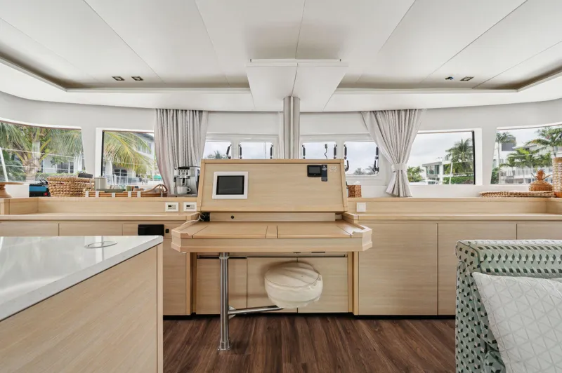 Nomada Yacht Photos Pics Luxurious interior of 2014 Lagoon 620 yacht with modern navigation station and panoramic windows.