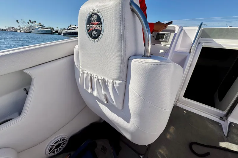 Jah Love Yacht Photos Pics Interior of a 2015 Donzi 38 ZR boat with white seating and logo.