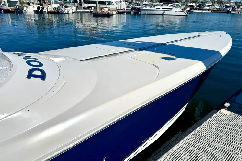 Jah Love Yacht Photos Pics 2015 Donzi 38 ZR speedboat docked at a marina, showcasing sleek design and vibrant blue hull.