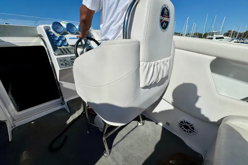 Jah Love Yacht Photos Pics 2015 Donzi 38 ZR boat cockpit with steering wheel and gauges, featuring white seating.