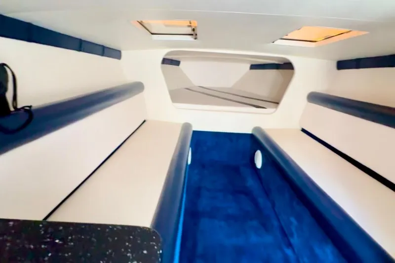Jah Love Yacht Photos Pics Interior of 2015 Donzi 38 ZR boat with blue and white seating.