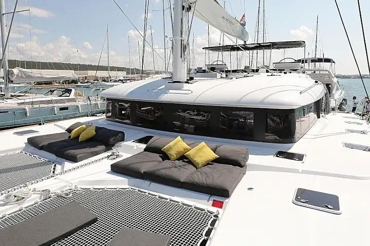 Masterdream Yacht Photos Pics Luxurious 2018 Lagoon 620 Esense yacht with sunbathing area and cushions on deck.