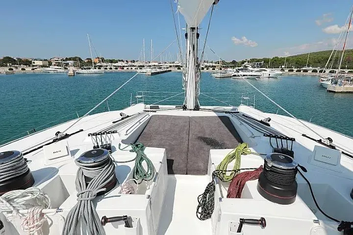 Masterdream Yacht Photos Pics Lagoon 620 Esense 2018 yacht deck with ropes and winches in a marina.