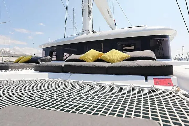 Masterdream Yacht Photos Pics Luxurious Lagoon 620 Esense 2018 yacht with sunbathing cushions and netting on deck.