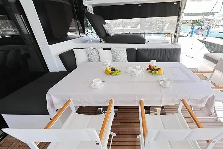 Masterdream Yacht Photos Pics Luxurious Lagoon 620 Esense 2018 yacht interior with elegant dining setup and comfortable seating.