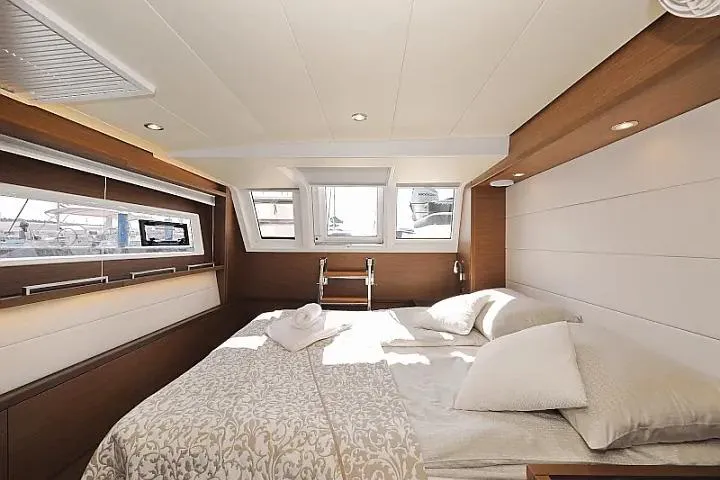 Masterdream Yacht Photos Pics Luxurious cabin interior of 2018 Lagoon 620 Esense yacht with elegant bedding and natural light.