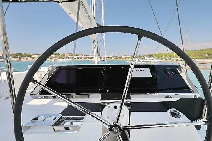 Masterdream Yacht Photos Pics Steering wheel of 2018 Lagoon 620 Esense yacht with navigation controls.