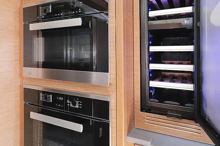 Masterdream Yacht Photos Pics Modern kitchen appliances in Lagoon 620 Esense yacht, featuring ovens and a wine cooler.