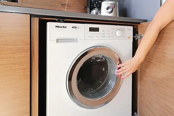 Masterdream Yacht Photos Pics Modern washing machine in wooden cabinet on Lagoon 620 Esense yacht, 2018 model.