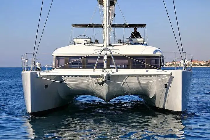 Masterdream Yacht Photos Pics 2018 Lagoon 620 Esense catamaran sailing on calm blue waters.