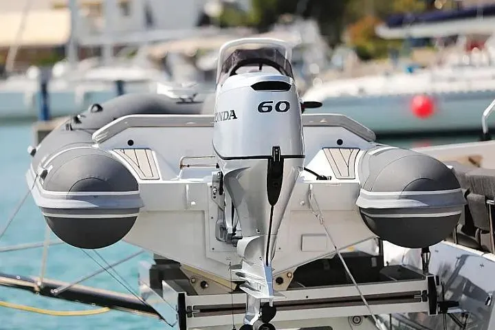 Masterdream Yacht Photos Pics Outboard motor on a 2018 Lagoon 620 Esense yacht, docked at a marina.