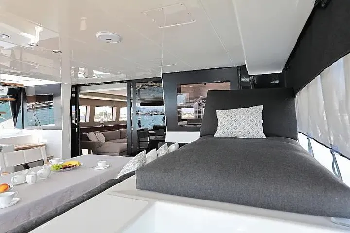 Masterdream Yacht Photos Pics Luxurious interior of 2018 Lagoon 620 Esense yacht with modern furnishings and dining area.