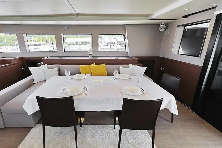 Masterdream Yacht Photos Pics Luxurious dining area inside 2018 Lagoon 620 Esense yacht, featuring elegant table setting and modern decor.